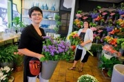 Girl from a flowershop shows her flowers