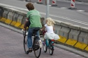 Father and daughter cycling on their way